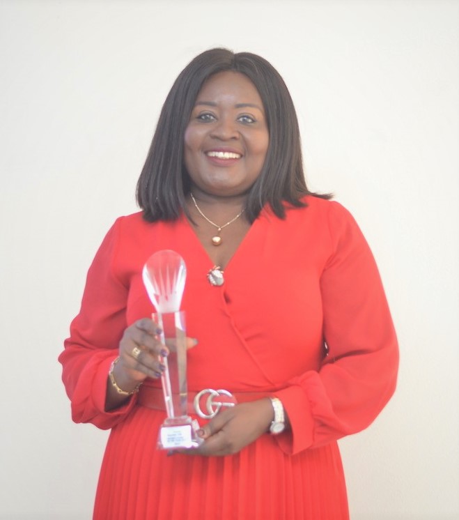 Nana Essilfuah Boison of Absa Bank holding the Enactus Award